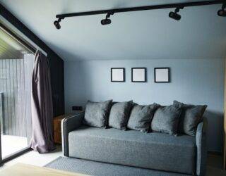 A living room next to large glass doors that are pouring light in.