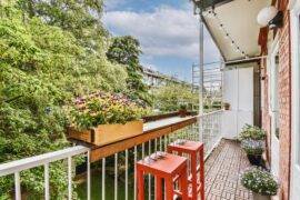 A narrow balcony with a small table built into the railing.