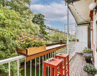 A narrow balcony with a small table built into the railing.