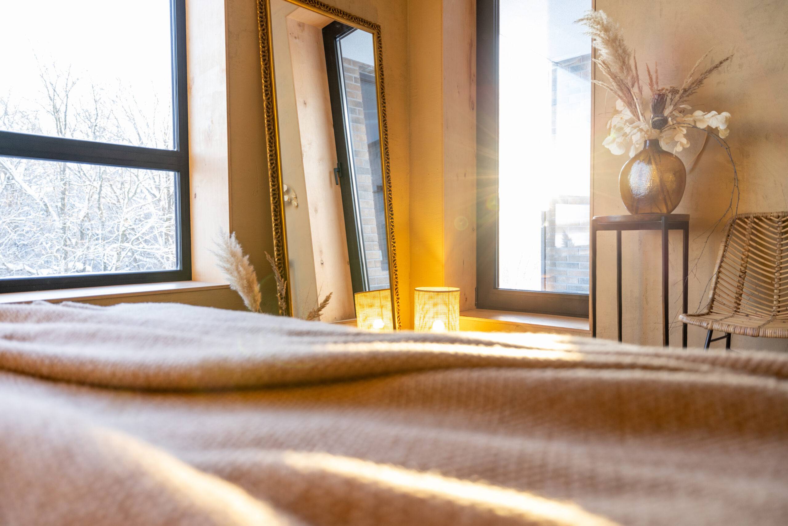 Stylish beige bedroom interior in natural boho style during a morning sunshine