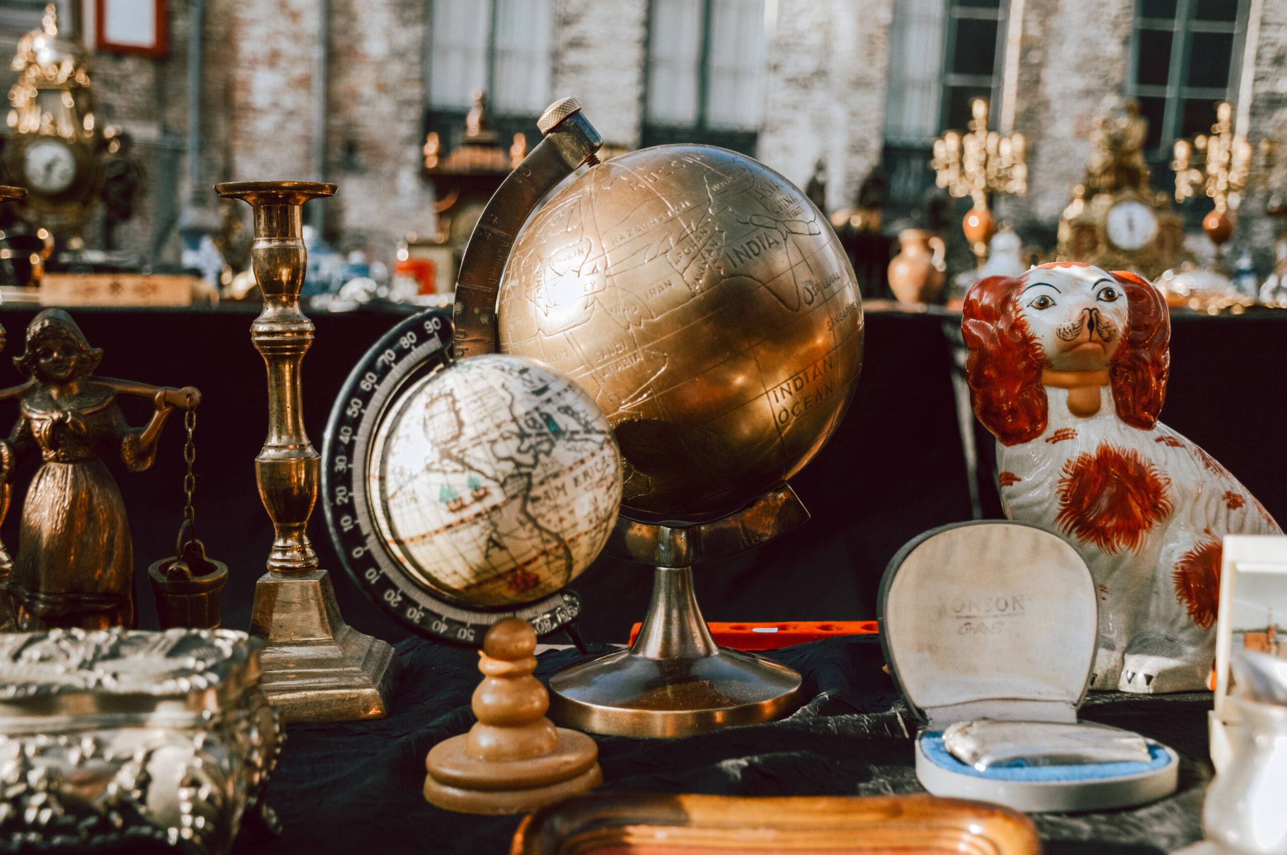 A close photo of a table filled with various antique decor.