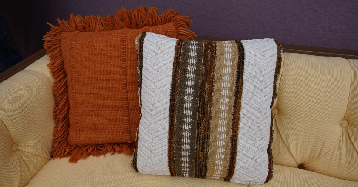 Striped cushio against solid shades in living room decor.